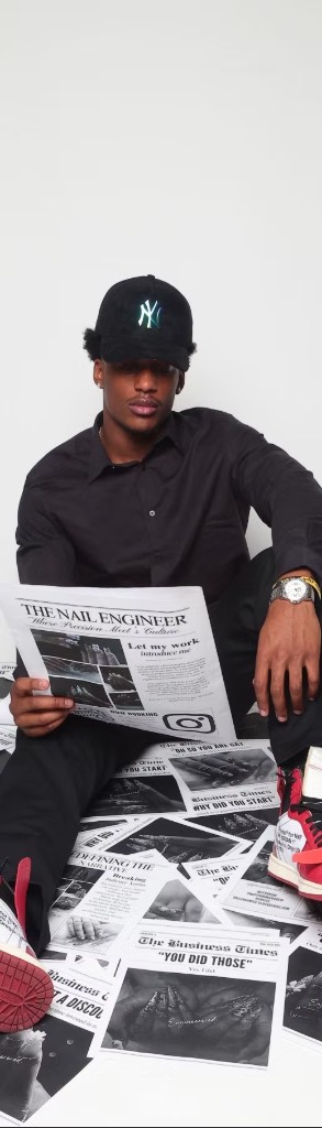 Jayden with The Nail Engineer branded newspapers